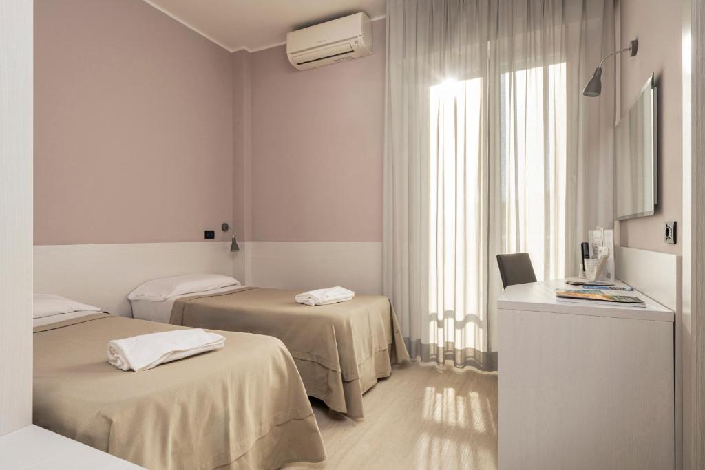 Кровать или кровати в номере Hotel Mondial