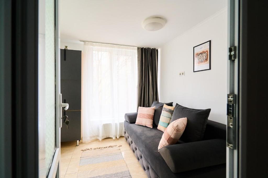 a living room with a couch and a window at Smart Stay Valea Crucii Near Botanical Garden in Chişinău