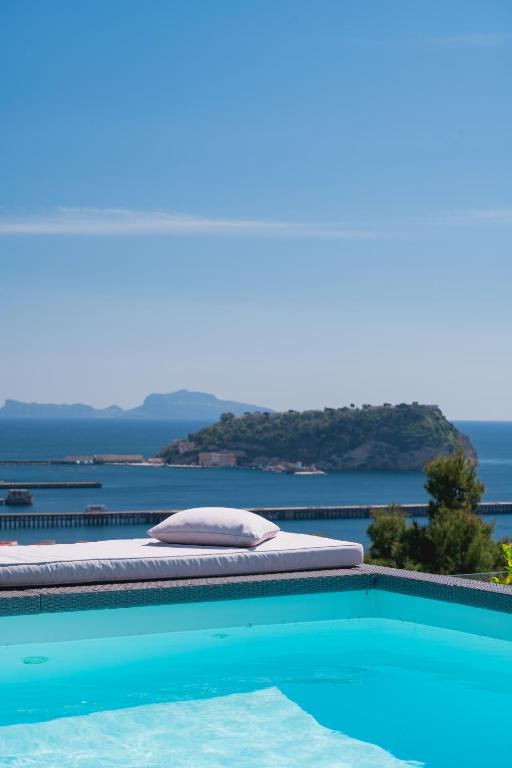 a bed sitting next to a swimming pool at Golden Garden in Naples