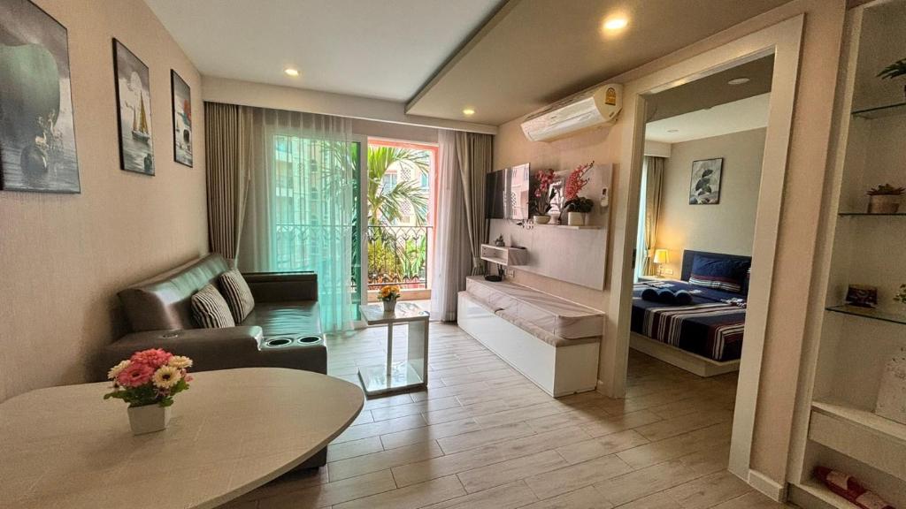 a living room with a couch and a table at seven sea F508 in Jomtien Beach