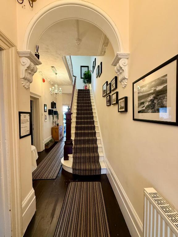 a hallway with a spiral staircase in a house at The Hedley Townhouse in Bournemouth