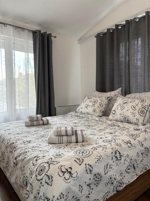 a bed with two pillows on it in a bedroom at APARTMENT SIYANA in Panagyurishte