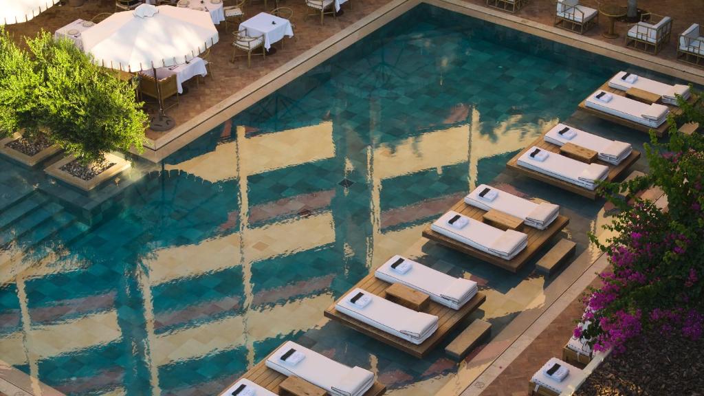 an overhead view of a pool with parked cars at The Margi in Athens