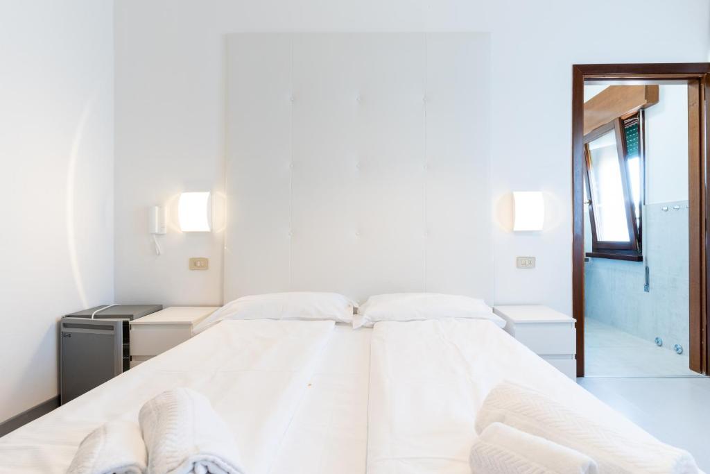 Postel nebo postele na pokoji v ubytování Hotel Regina