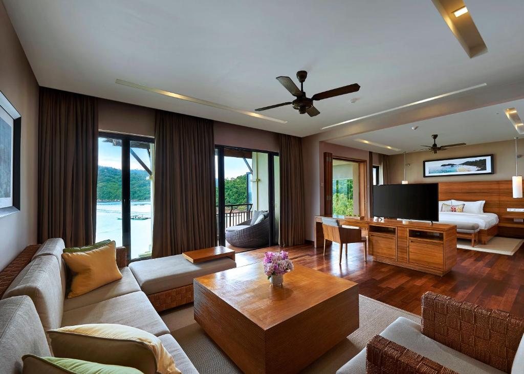 a living room with a couch and a table at The Taaras Beach & Spa Resort in Redang Island