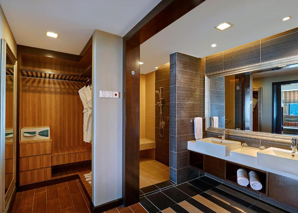 a bathroom with two sinks and a large mirror at The Taaras Beach & Spa Resort in Redang Island