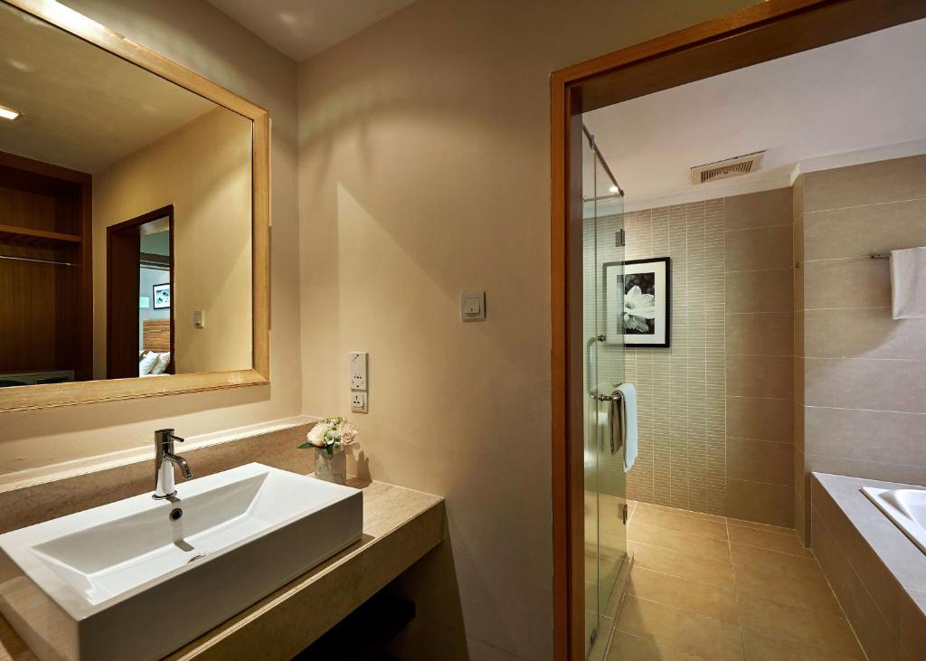 a bathroom with a sink and a shower at The Taaras Beach & Spa Resort in Redang Island