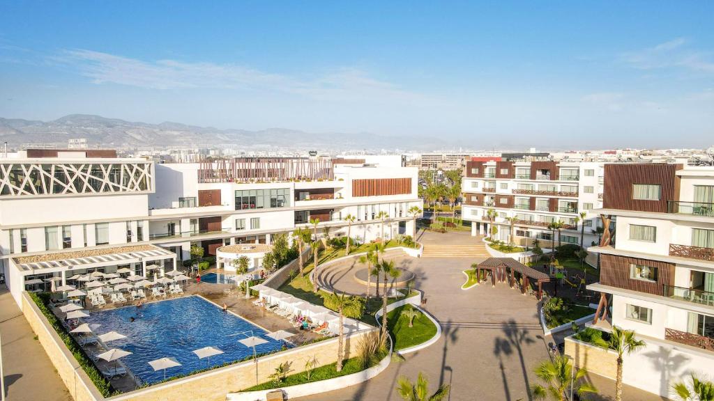 an aerial view of a city with buildings and a pool at Zephyr Agadir in Agadir