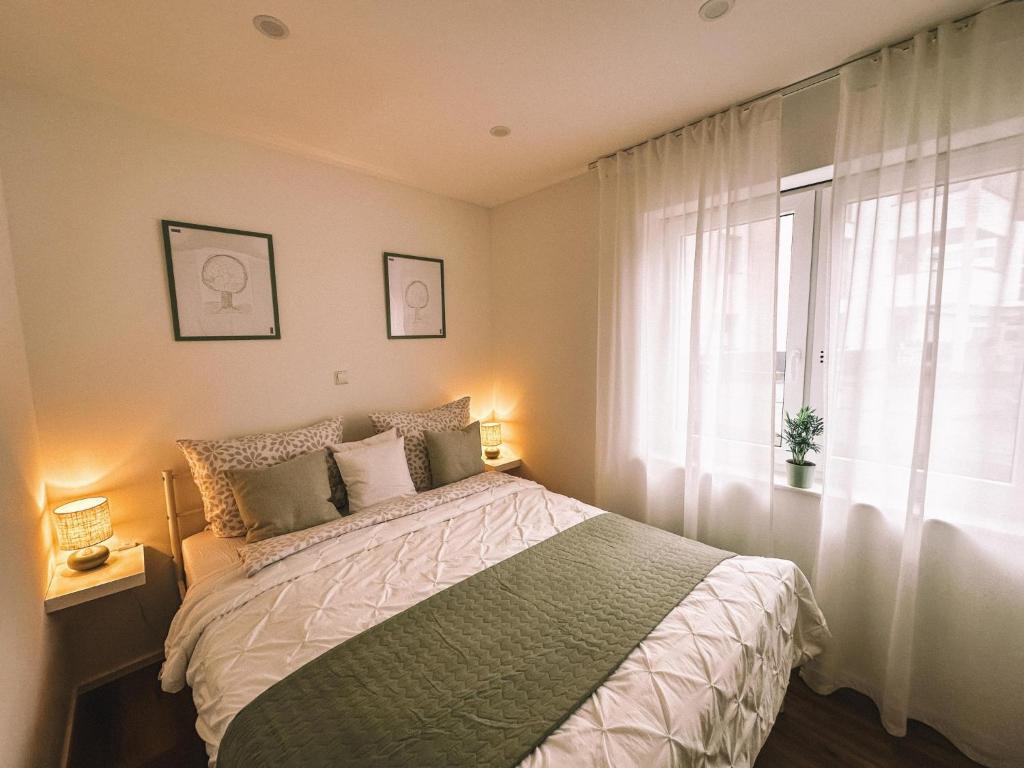 a bedroom with a large bed and a window at Ferieneleganz am Fluss in Bad Ems