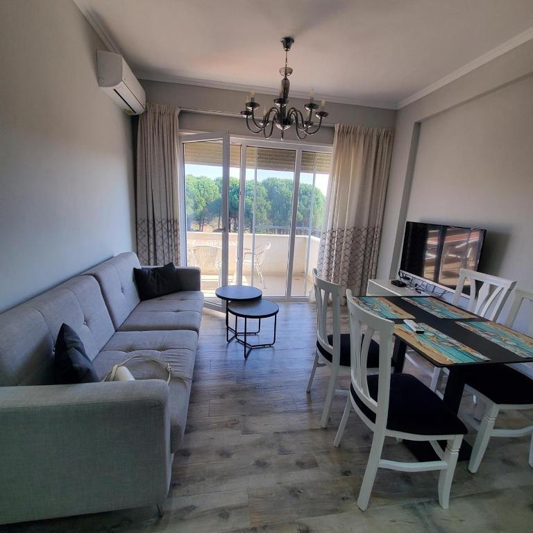 a living room with a couch and a table at Urban Charm Lalzi in Draç