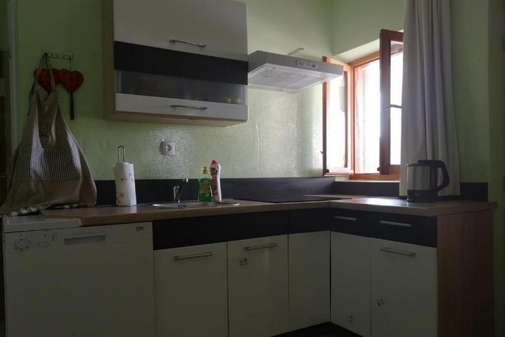 a kitchen with a sink and a counter top at Holiday house with a parking space Drvenik , Drvenik - 24088 in Dolići