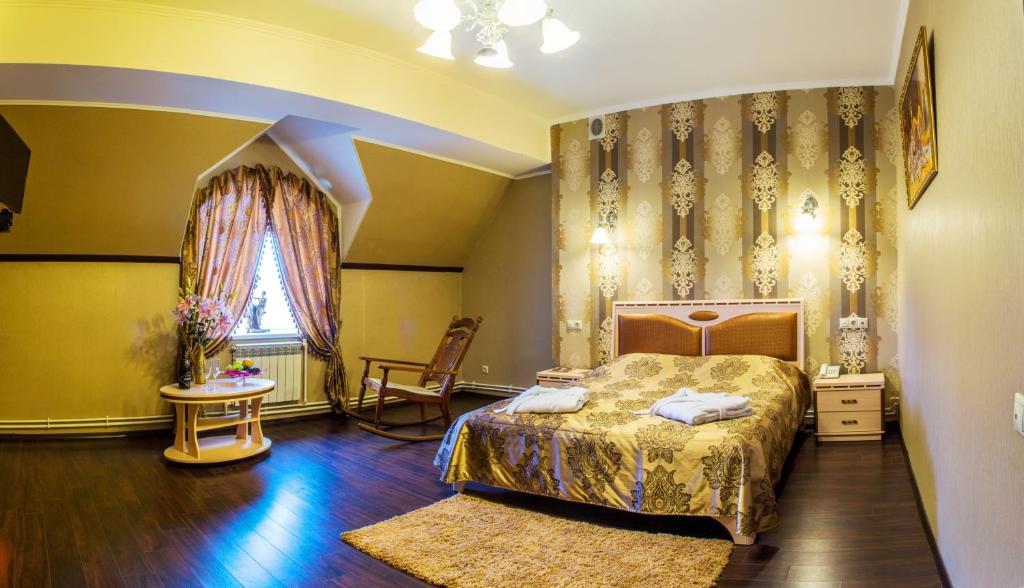 1 dormitorio con cama, mesa y ventana en KaroZa, en Petrovskoye