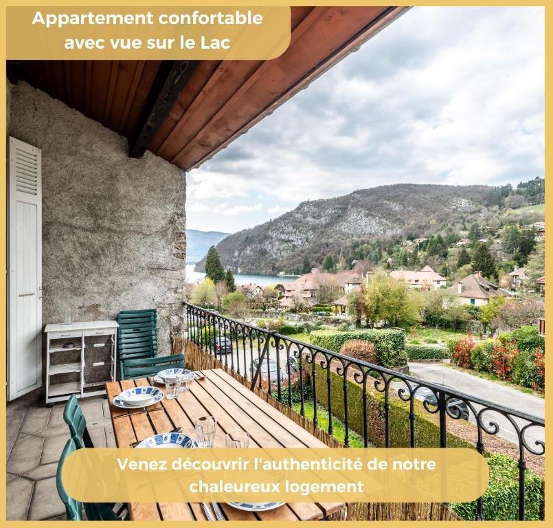 a balcony with a table and chairs and a view at Le Panorama d'Autrefois I T3 I Talloires in Talloires