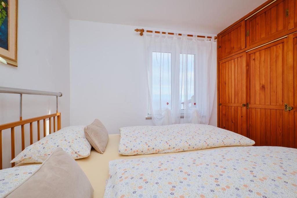 Postel nebo postele na pokoji v ubytování Apartments Katja