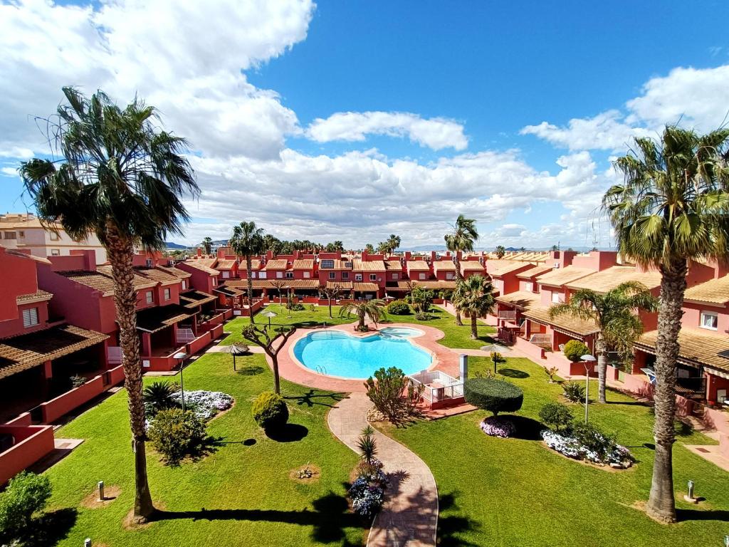an aerial view of a resort with a swimming pool and palm trees at Albatros Playa 2 - 5810 in Mar de Cristal
