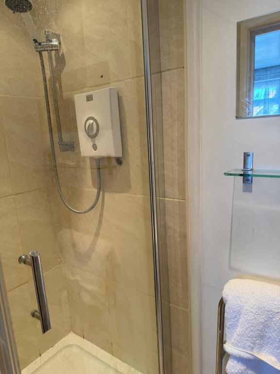 a shower with a glass door in a bathroom at South Sands Hotel in Weston-super-Mare