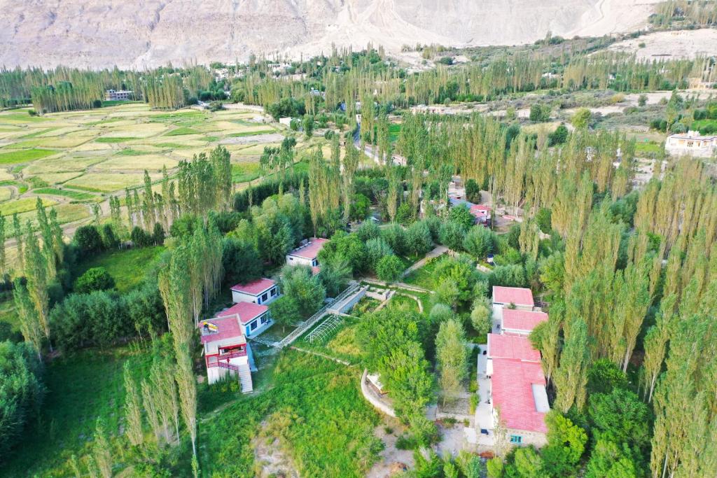 an aerial view of a village with houses and trees at Lharimo North Cottages - Nubra Valley in Wāhegaon