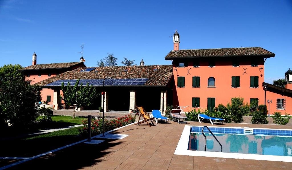 a house with a swimming pool next to a building at Isola Di Wight in San Michele al Tagliamento