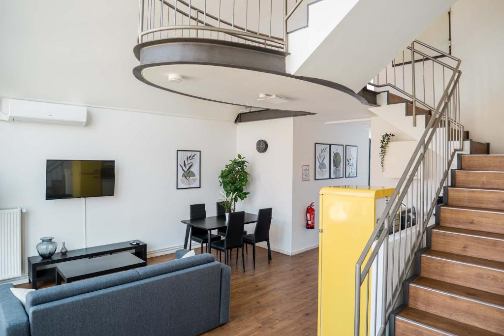 a living room with a staircase and a dining room at Fantastic Loft with Balcony in Berlin