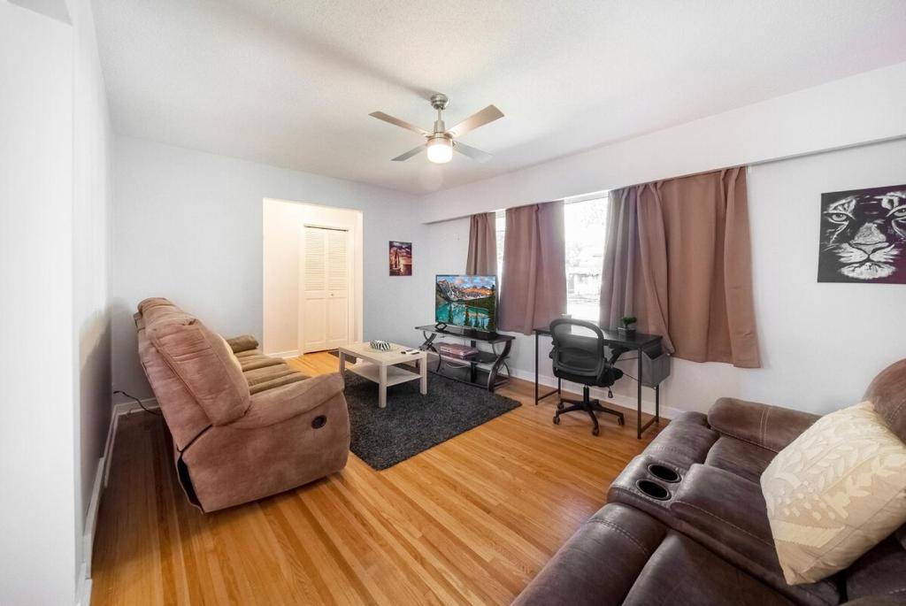 a living room with a couch and a chair at Beautiful Home In A Prime Location in Winnipeg