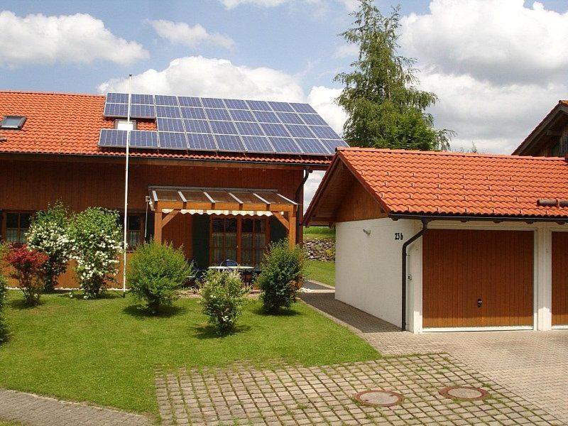 a house with a solar panel on the roof at Ferienhaus Fuchsweg im Feriendorf Reichenbach F23b in Nesselwang