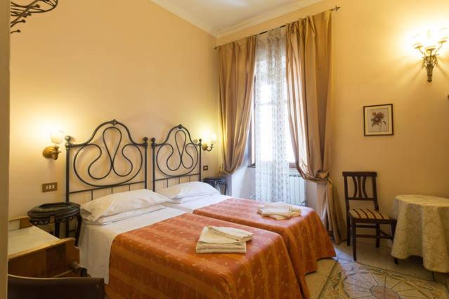 a bedroom with a large bed with a red blanket at Maison de Marta in Rome