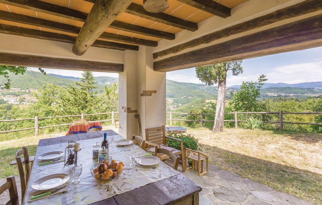 a table with a bowl of fruit on it on a patio at Baciola in Ortignano Raggiolo