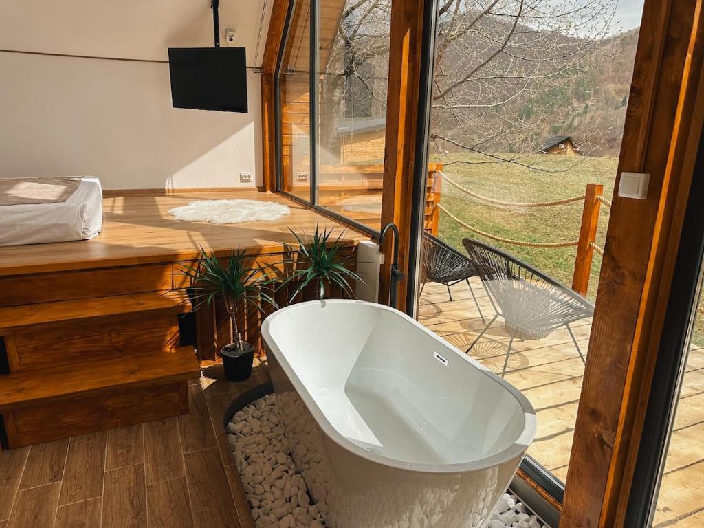 une salle de bain avec une baignoire devant une fenêtre dans l'établissement Luna by NorAtlas Heritage, à Varlaam