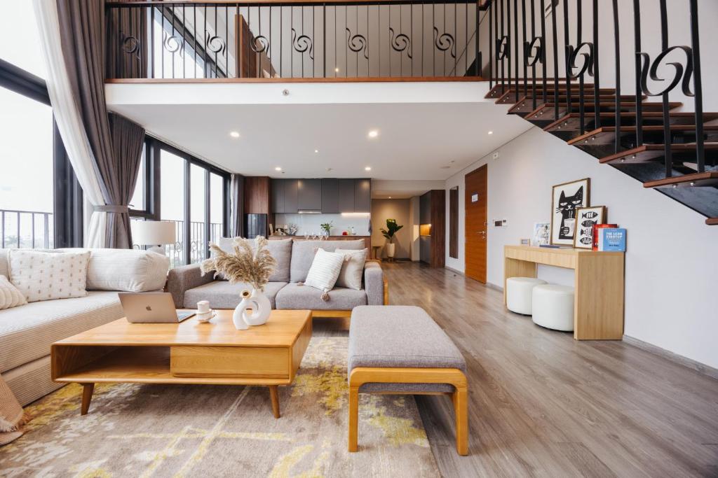 a living room with a couch and a table at PentStudio Duplex Apartment in Hanoi