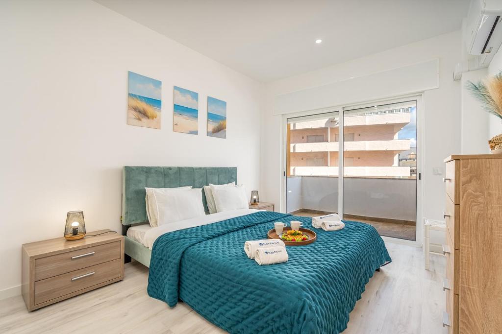 a bedroom with a bed with a tray of food on it at HostWise – Seaside Escape with Balcony in Silves