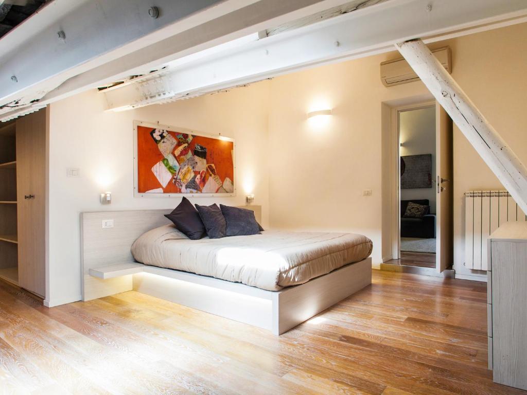 a bedroom with a bed in the middle of a room at Spanish Steps Luxury Penthouse in Rome