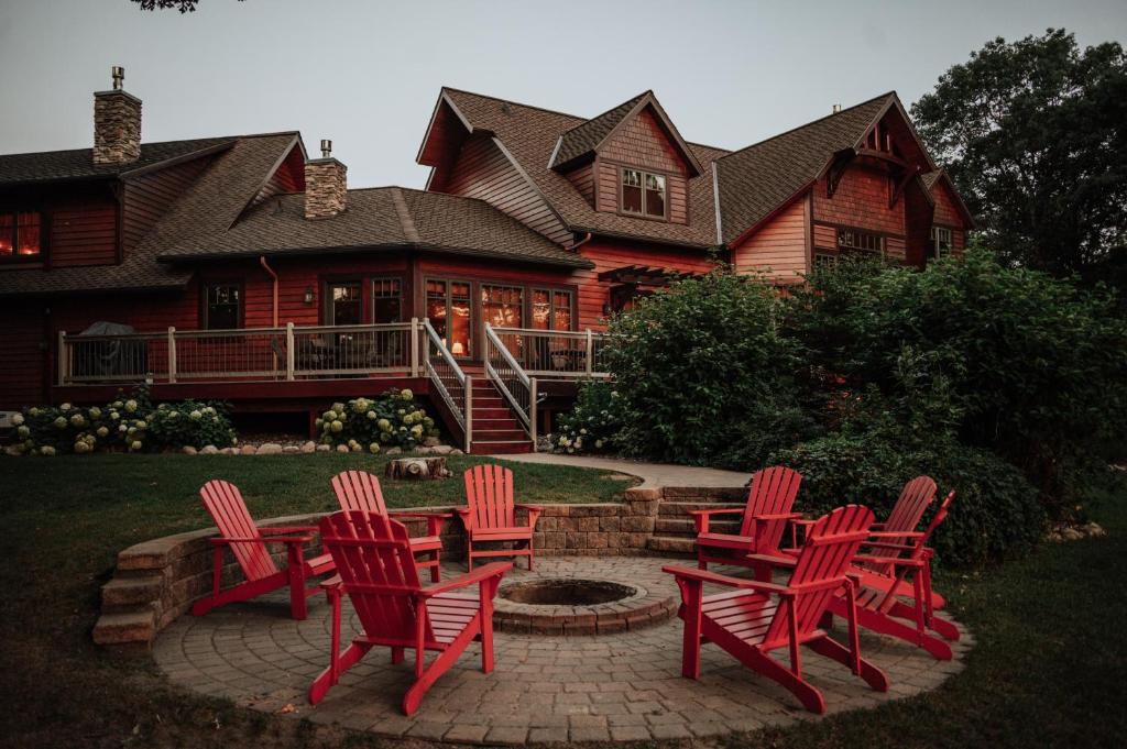 a group of red chairs in front of a house at Oak Haven in Laporte