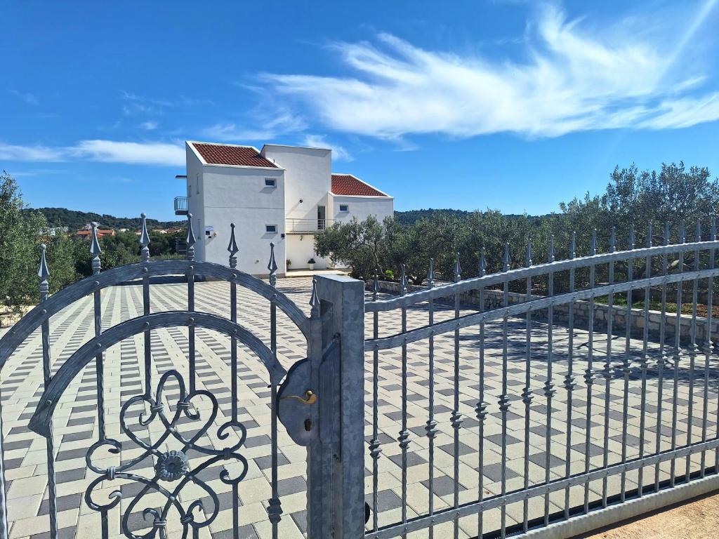 an iron gate in front of a building at Apartmani AS in Jezera
