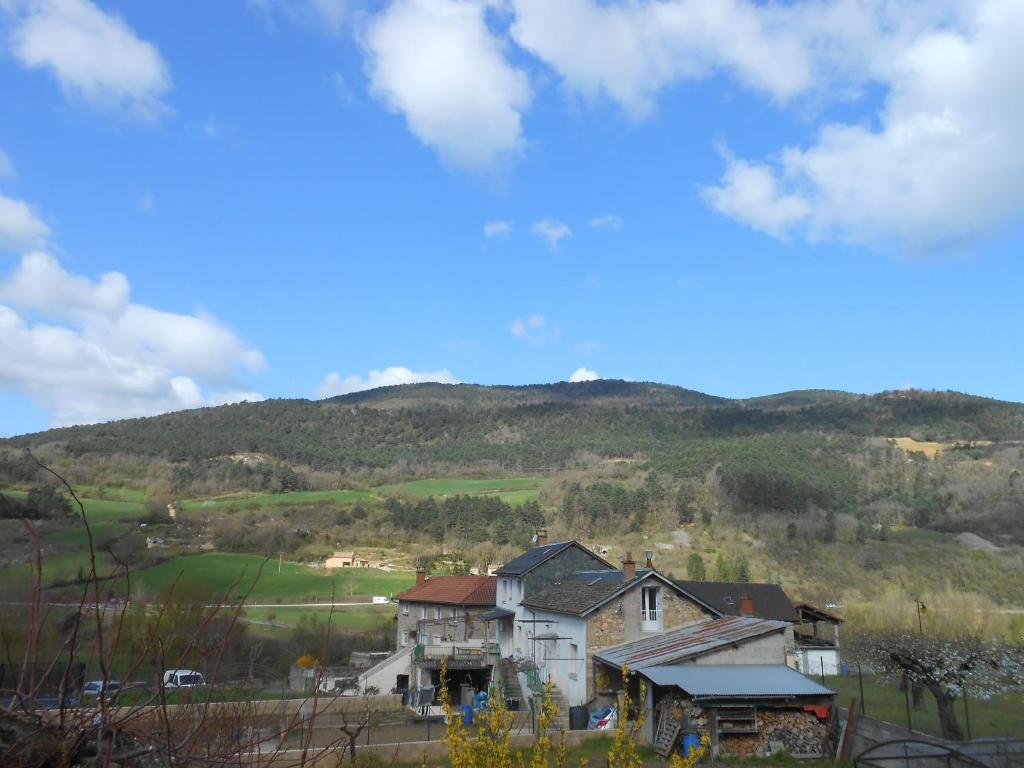 a house with a mountain in the background at Gite du plô in La Cresse