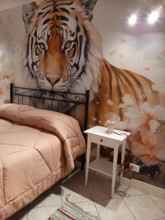 a bedroom with a tiger mural on the wall at La Collina in Sacrofano