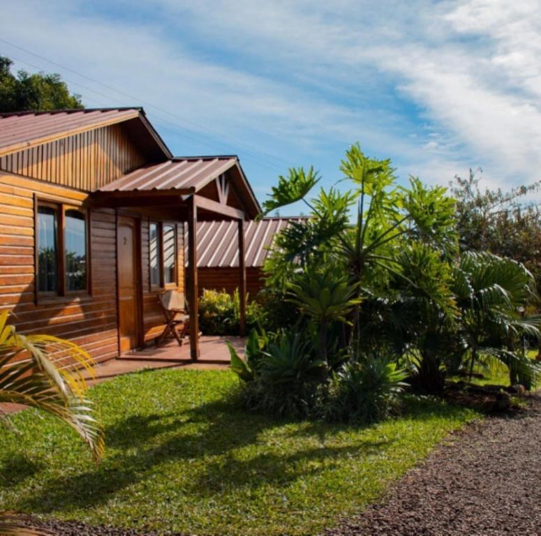 a wooden house with a gazebo and some plants at Cabañas Doralia in Oberá