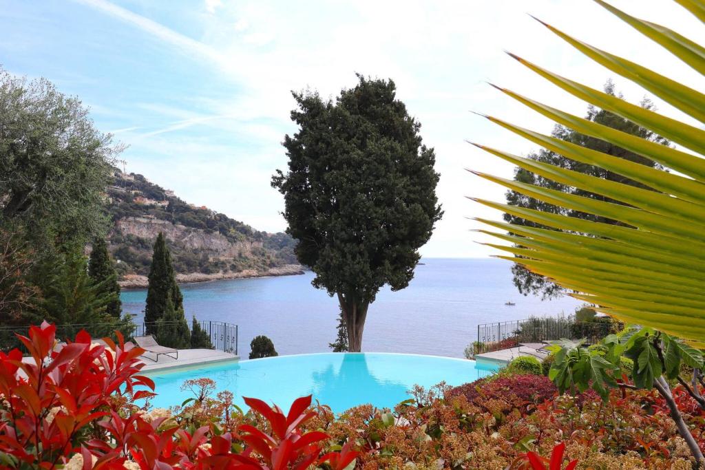 a view of the ocean from a garden at Diodato Luxury Residence Corbusier Promenade & Sea View with Pool #3 in Roquebrune-Cap-Martin