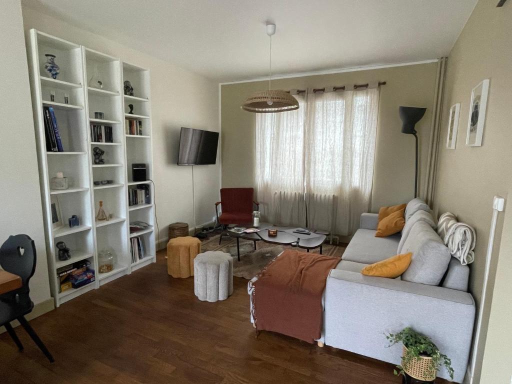 a living room with a couch and a table at Chez Léonine, maison en centre ville in Tours