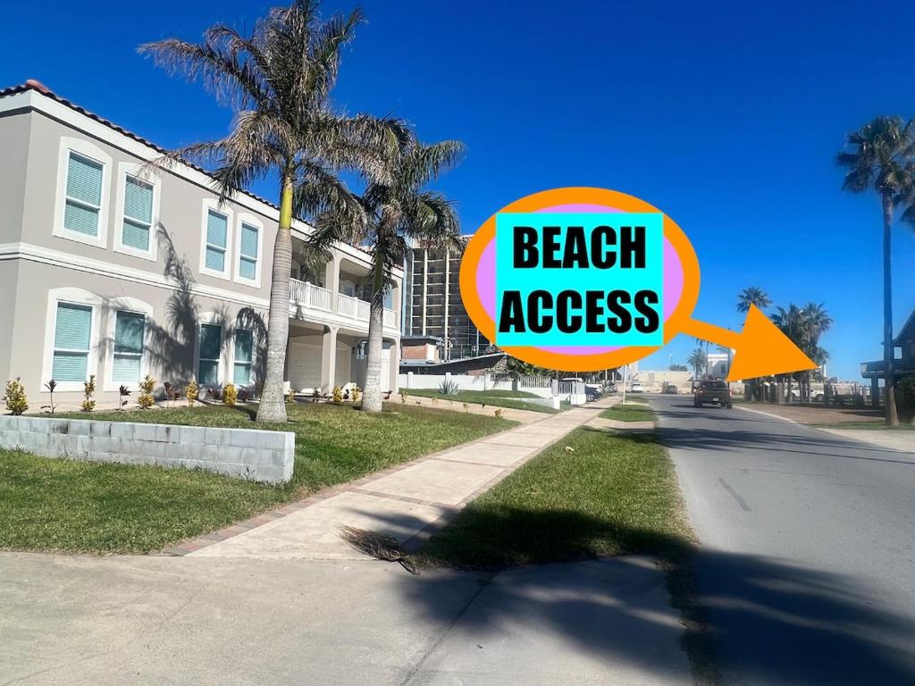 a beach access sign on the side of a street at FamReunion,EVcharger,3LotsToBeach,HeatedPool,Jacuzzi in South Padre Island