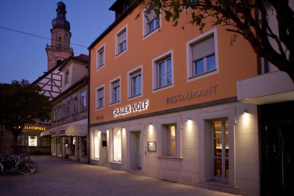 a street in a town at night with a building at Altstadthotel Grauer Wolf in Erlangen