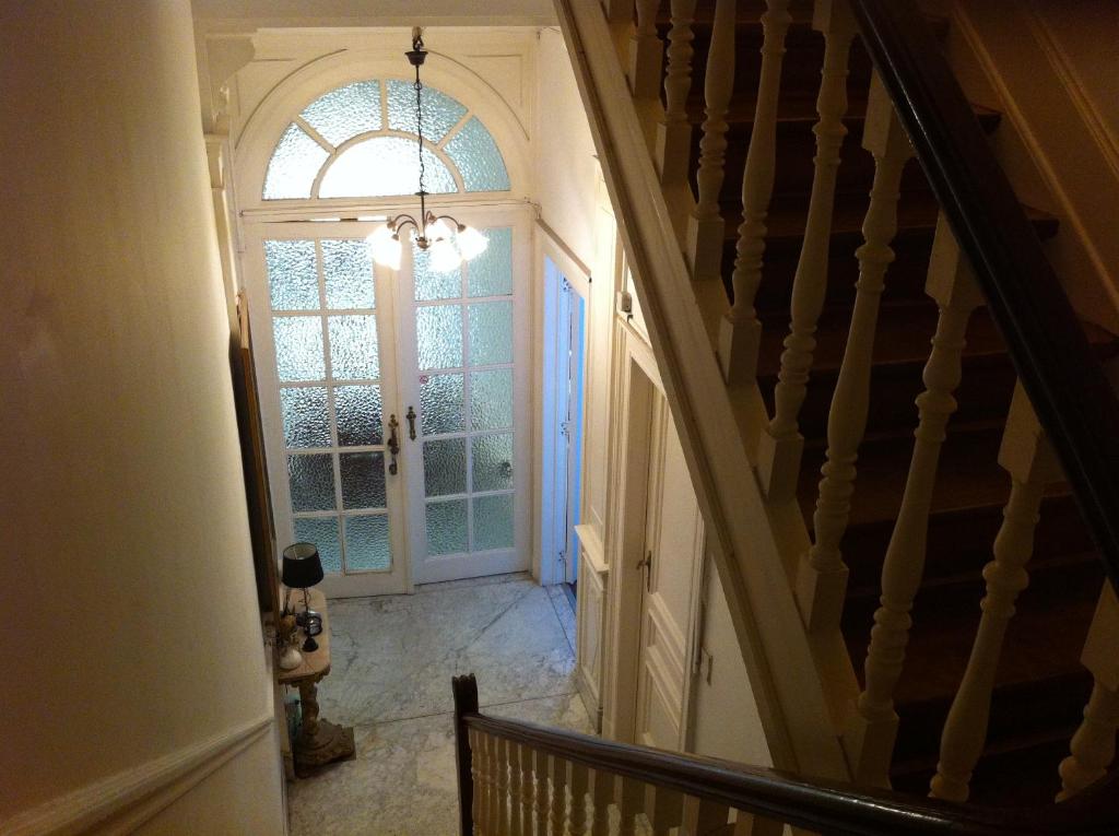 a room with a staircase leading to a balcony at Résidence18 in Brussels