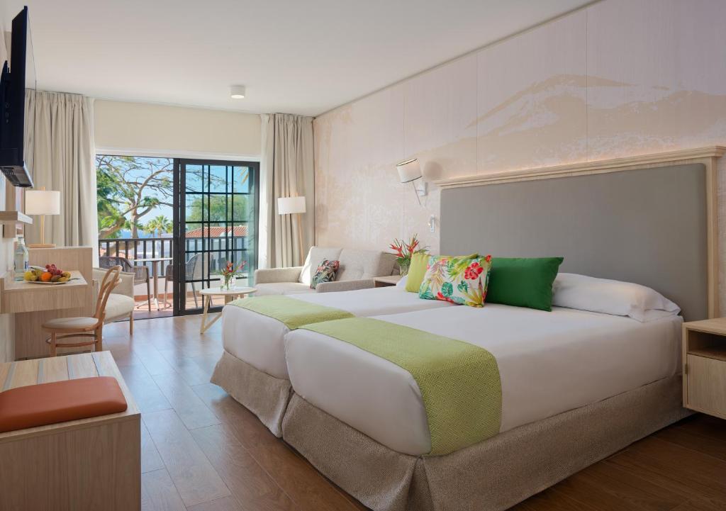 a large bedroom with a large bed in a room at Hotel Jardín Tecina in Playa de Santiago