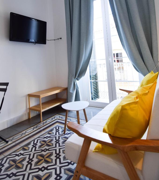 Televízia a/alebo spoločenská miestnosť v ubytovaní Letmalaga Soho Apartments