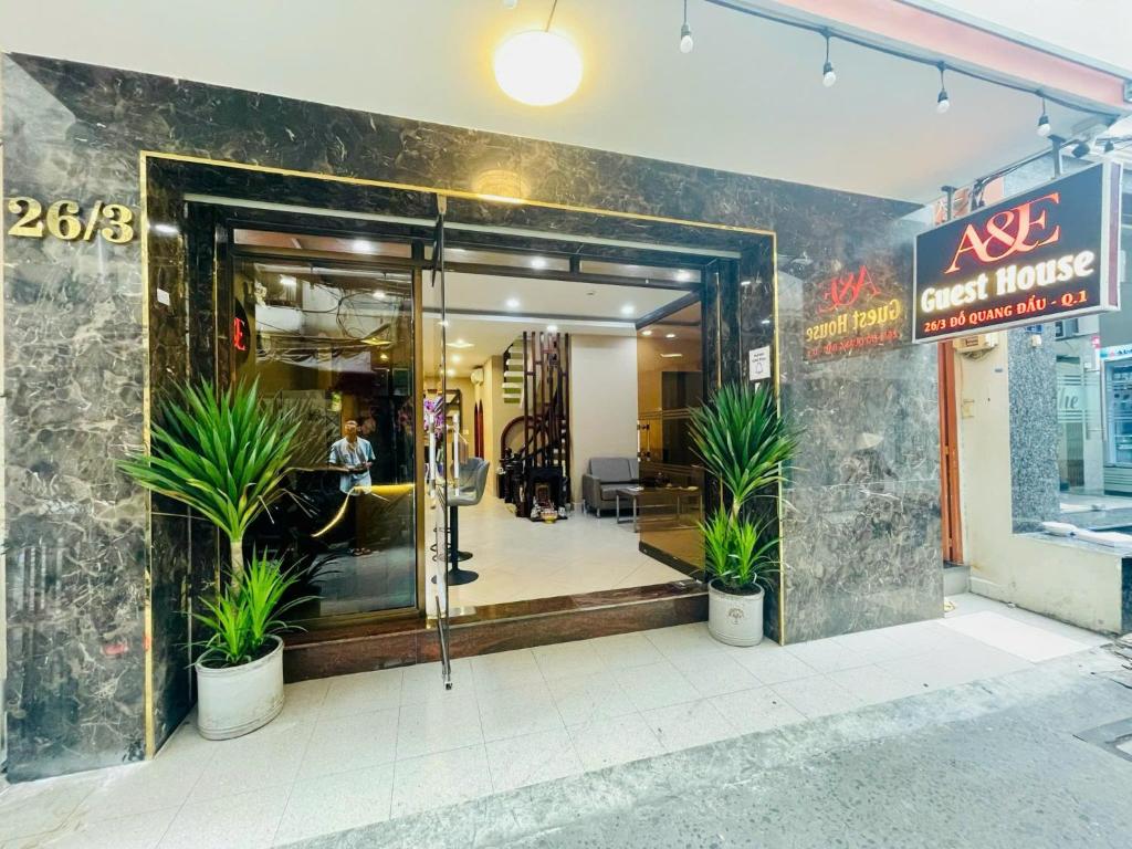 a store entrance with potted plants in front of it at A&E Guesthouse in Ho Chi Minh City