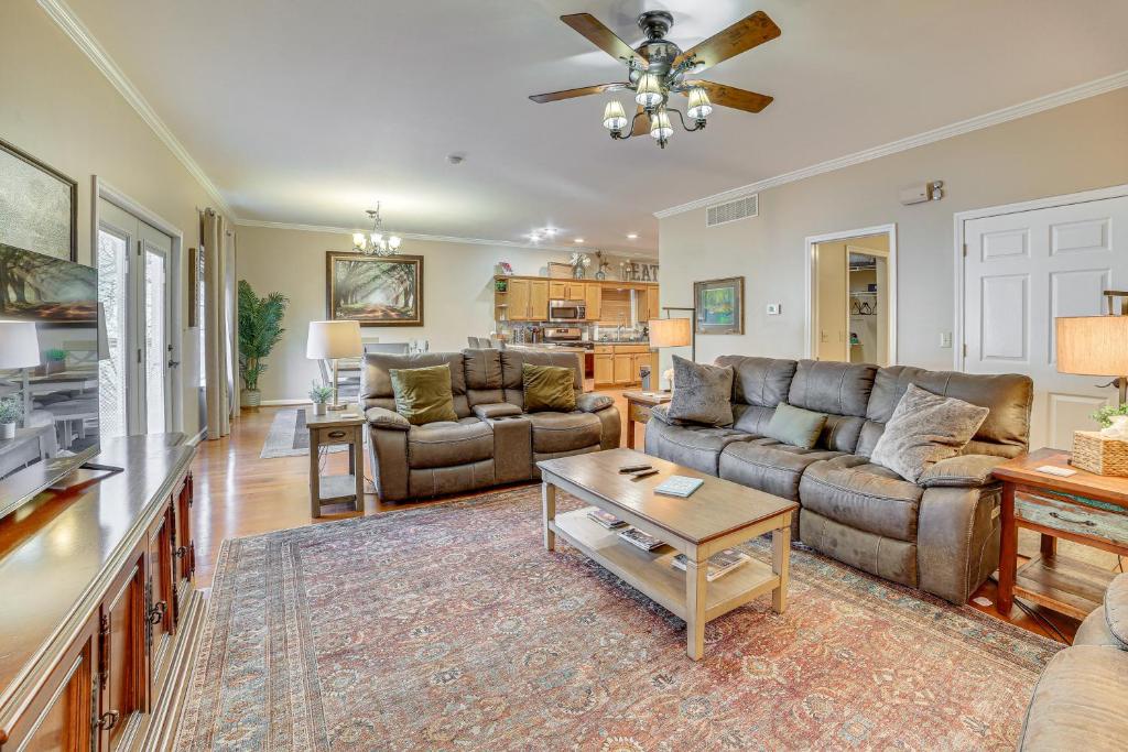 a living room with two couches and a table at 2 Mi to Branson Landing Quiet Home with Lake View in Branson