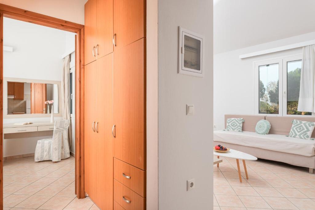 A bed or beds in a room at Naftilos Rosmarinus Apartments