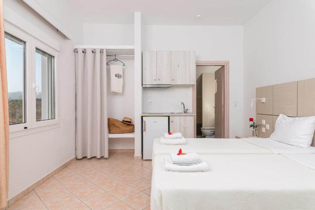 A bed or beds in a room at Naftilos Rosmarinus Apartments