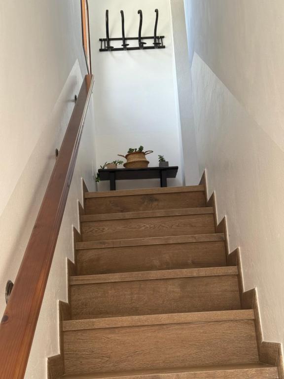 a stairway with wooden stairs and a table at Apartamentos Bolonia - M a n u e l a in Bolonia