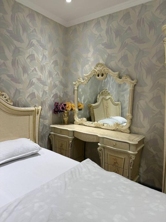 a bedroom with a mirror and a bed at Bonushka 5 in Uzbankinty