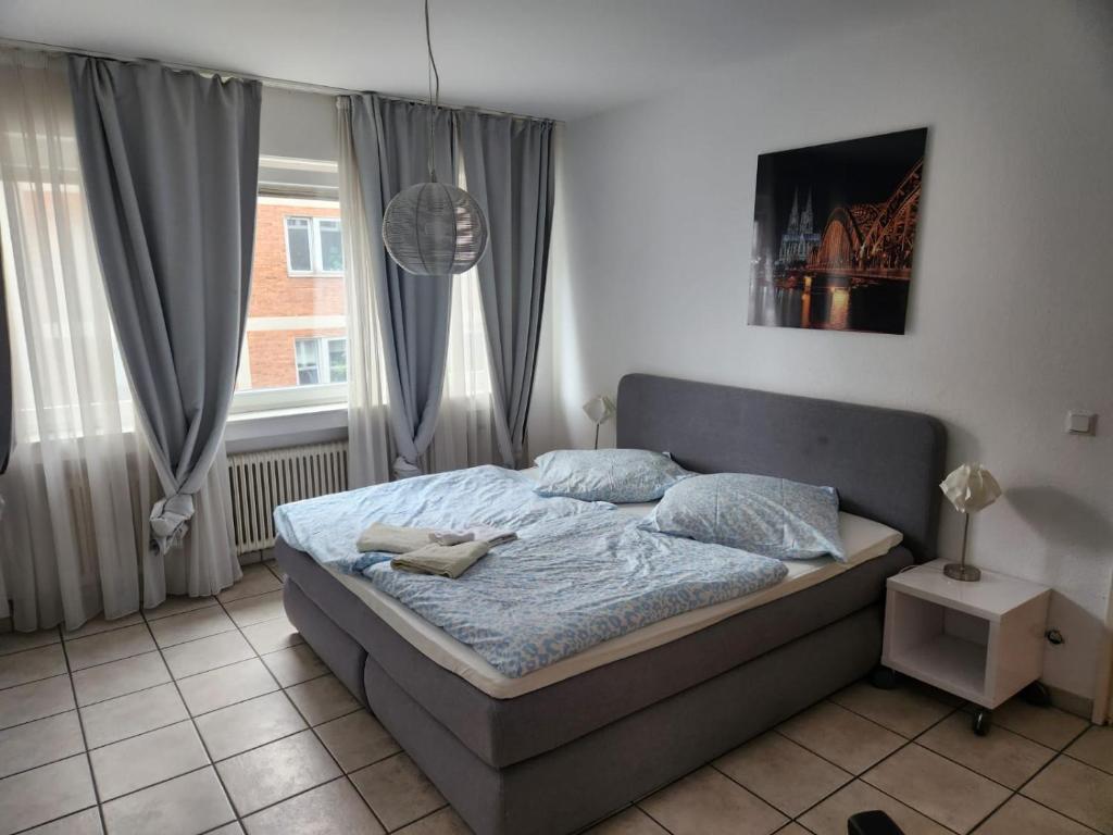a bedroom with a bed and a window at Cozy Aparment 4 at Cathedral in Cologne
